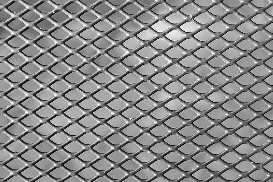 Close-up of gray metal mesh grid texture pattern