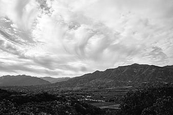 Dramatic Black and White Mountain Landscape with Swirling Clouds