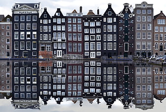Reflections of historic canal houses in Amsterdam, Netherlands