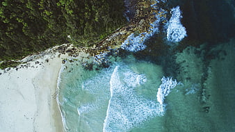 Aerial View of Turquoise Ocean Waves Crashing on Sandy Beach