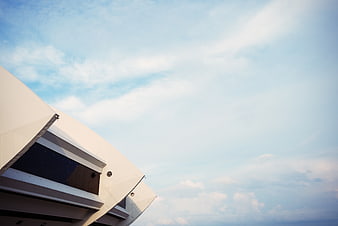 Modern stadium architecture against blue sky with clouds