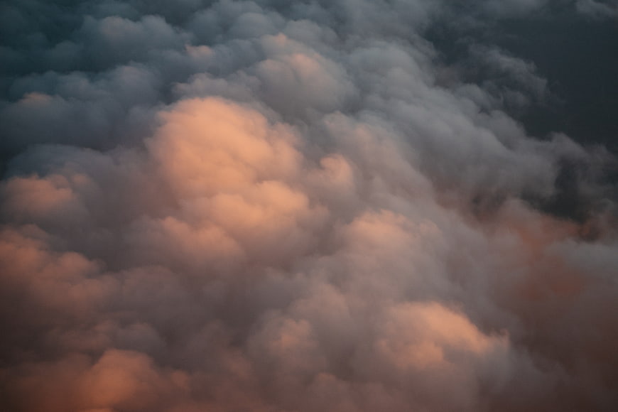 Dramatic sunset clouds with warm orange and dark blue tones