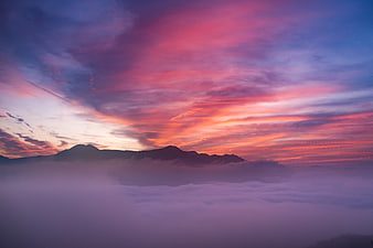 Dramatic Pink and Purple Sunset Over Mountain Silhouette
