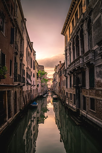 Venetian Canal at Sunset with Reflections and Boats