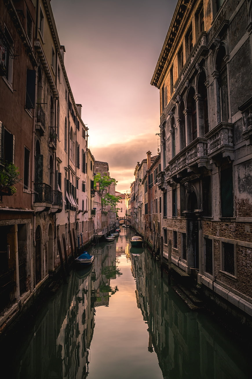 Venetian Canal at Sunset with Reflections and Boats