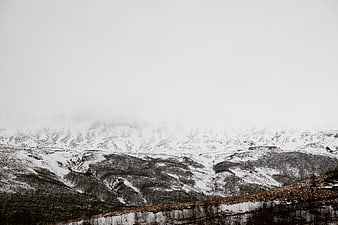 Snowy Mountain Landscape with Fog and Mist