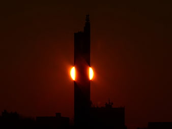 Grain Silo Silhouette With Fiery Sunset Glow