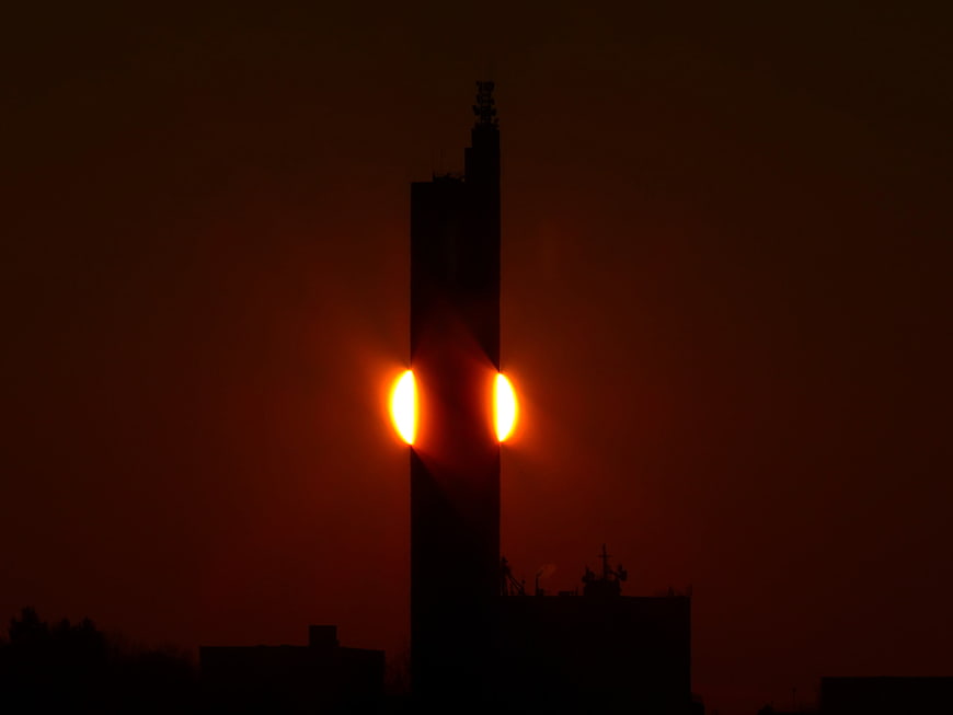 Grain Silo Silhouette With Fiery Sunset Glow