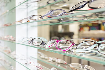 Eyeglasses Displayed on Glass Shelves in Optician Store