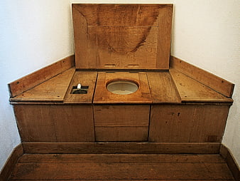 Antique wooden chamber pot toilet with porcelain bowl and wash basin