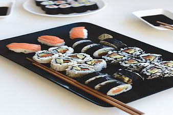 Assorted Sushi Platter with Nigiri and Rolls on Black Tray