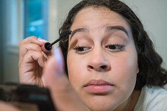 Close-up of woman applying mascara to eyelashes