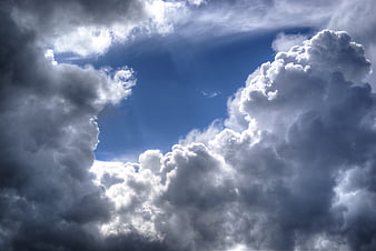 Dramatic Cumulonimbus Clouds Framing Blue Sky