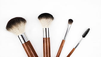 Set of wooden makeup brushes on white background