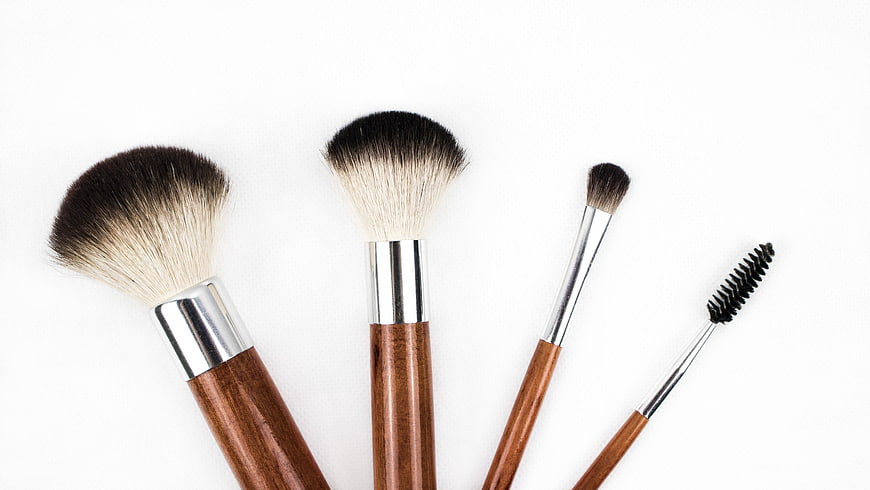 Set of wooden makeup brushes on white background
