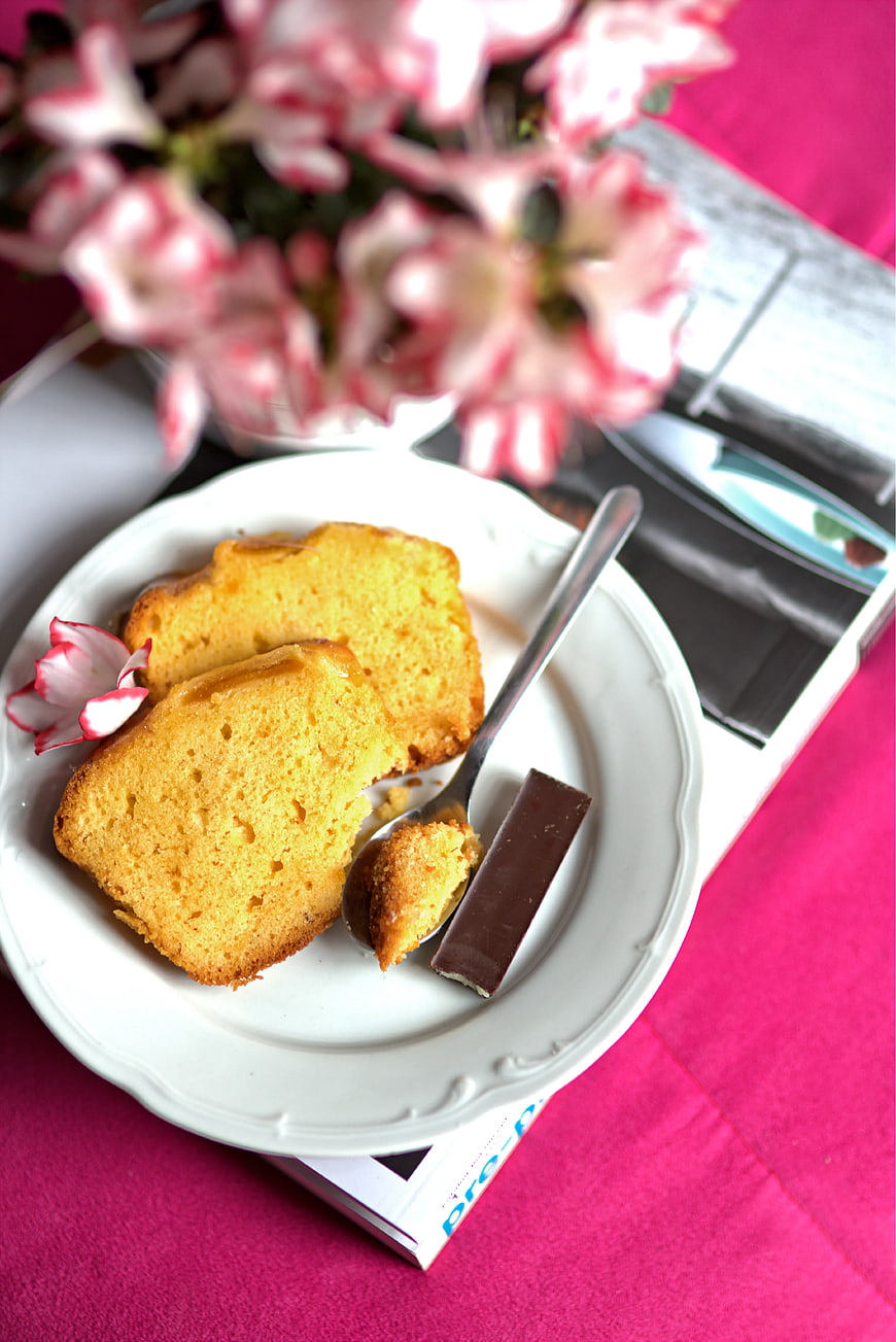 Slices of yellow sponge cake on white plate with chocolate
