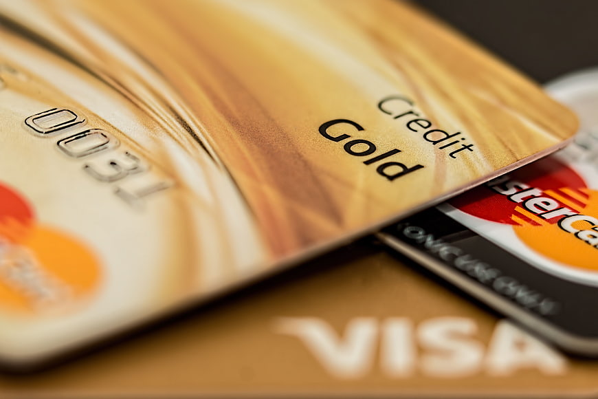 Close-up of Gold Credit Cards with VISA and Mastercard Logos
