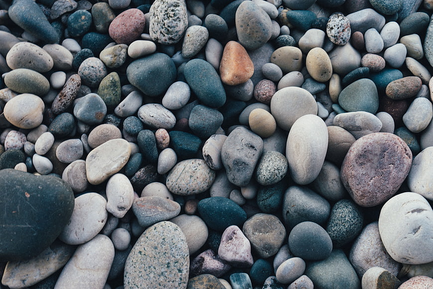 Close-up of smooth multicolored pebbles and stones on a beach