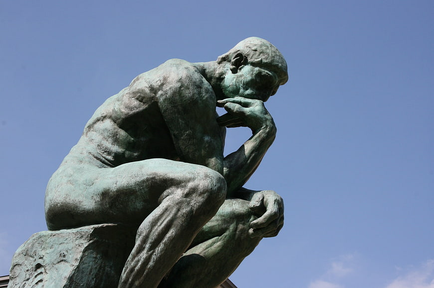 The Thinker Sculpture by Rodin Against Blue Sky