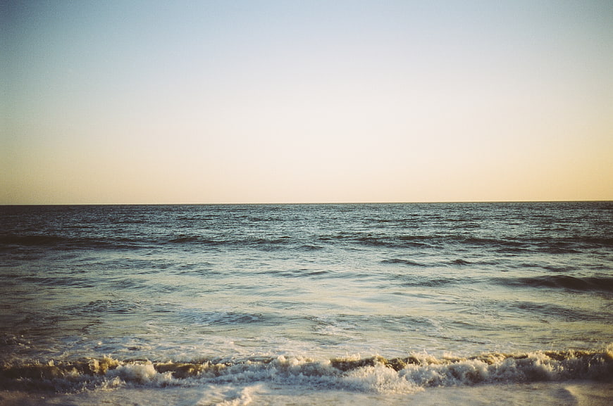 Cinematic Ocean Waves at Sunset with Vintage Film Grain
