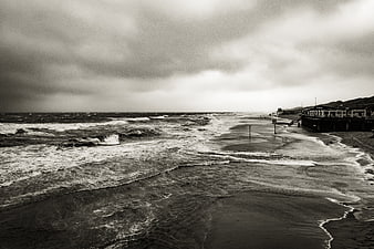 Dramatic Black and White Stormy Beach with Pier