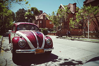 Vintage Red and White Volkswagen Beetle on Sunny Street