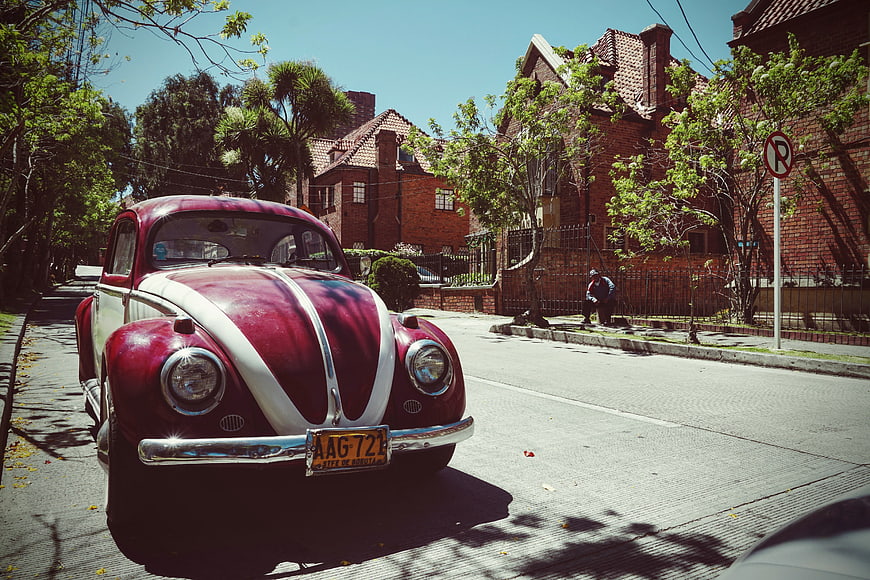 Vintage Red and White Volkswagen Beetle on Sunny Street