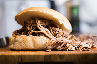 Close-up of a Hearty Pulled Pork Sandwich on a Wooden Board