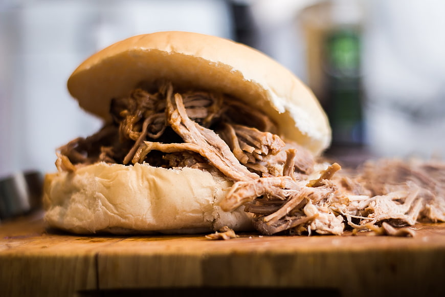 Close-up of a Hearty Pulled Pork Sandwich on a Wooden Board