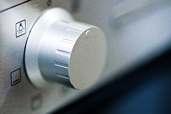 Close-up of silver audio control knob on amplifier