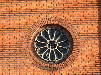 Gothic Rose Window on Red Brick Church Wall