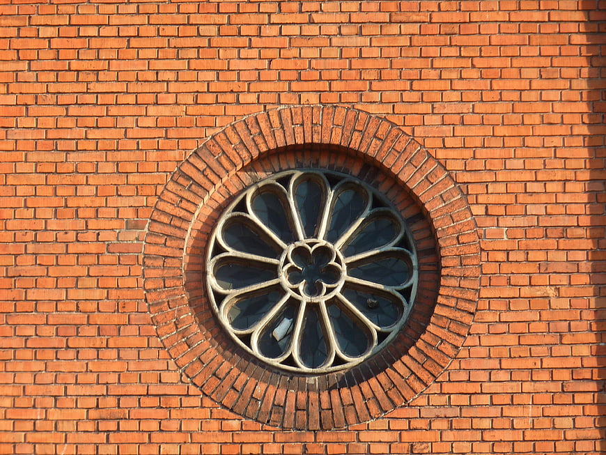 Gothic Rose Window on Red Brick Church Wall