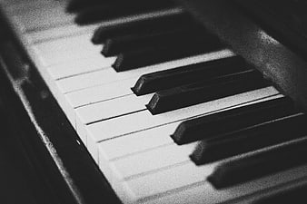 Close-up of vintage piano keys in black and white