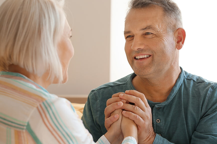 Happy Senior Couple Holding Hands and Smiling