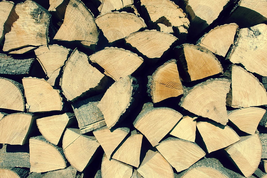 Stacked firewood logs with natural wood texture