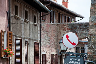 Old Italian village street with artisan shop sign and rustic architecture