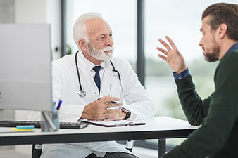 Senior Doctor Consulting with Patient in Modern Office