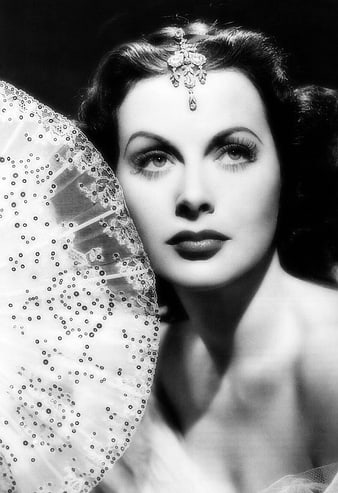 Vintage black and white portrait of glamorous woman with fan