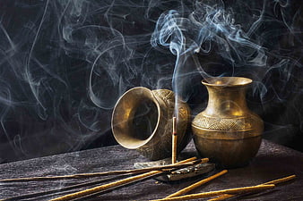 Smoking Incense Sticks in Brass Vessels on Dark Wood