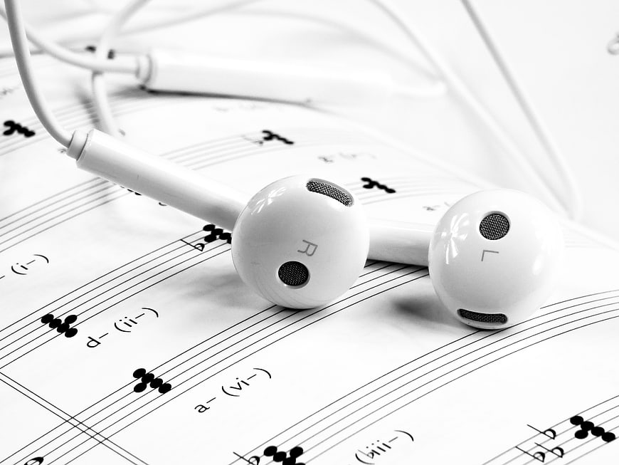 White Earphones on Sheet Music