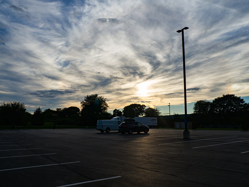 Sunset over Empty Parking Lot with Dramatic Clouds