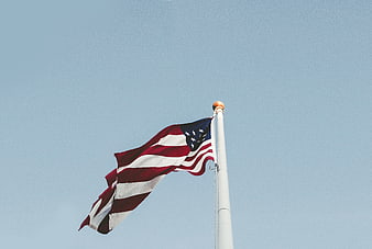 American Flag Waving Against Clear Blue Sky