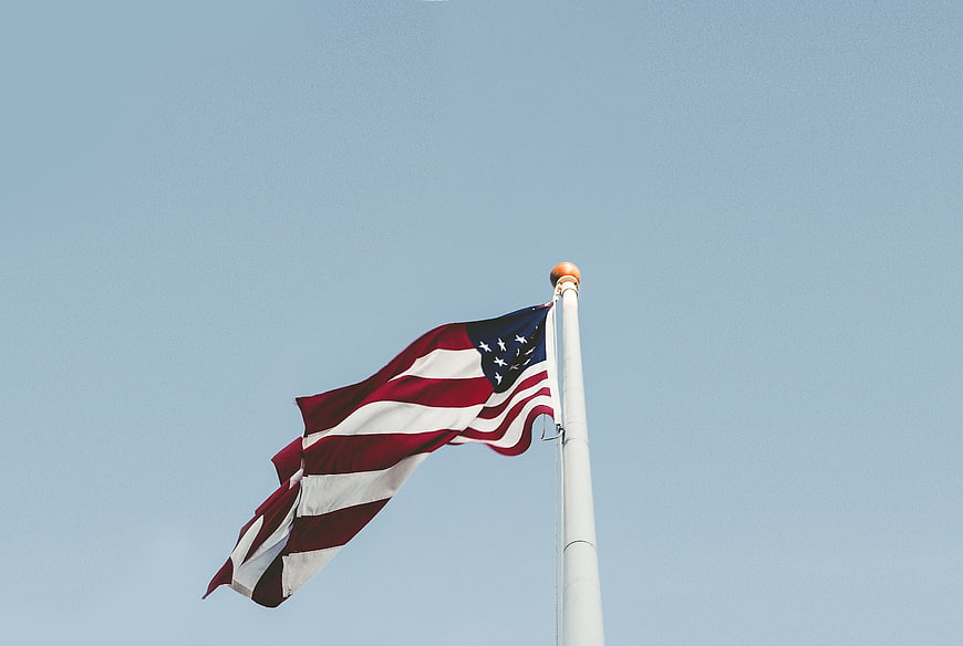 American Flag Waving Against Clear Blue Sky