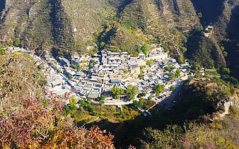 Aerial view of traditional village nestled in mountain valley