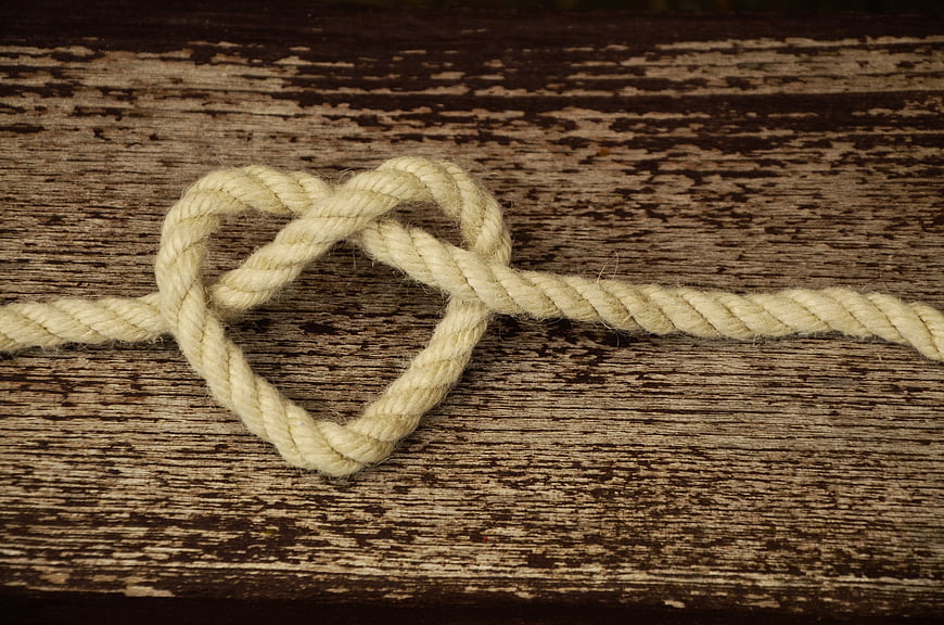 Rope Heart Knot on Weathered Wooden Background