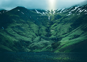 Dramatic Green Mountain Valley with Waterfalls and Snow