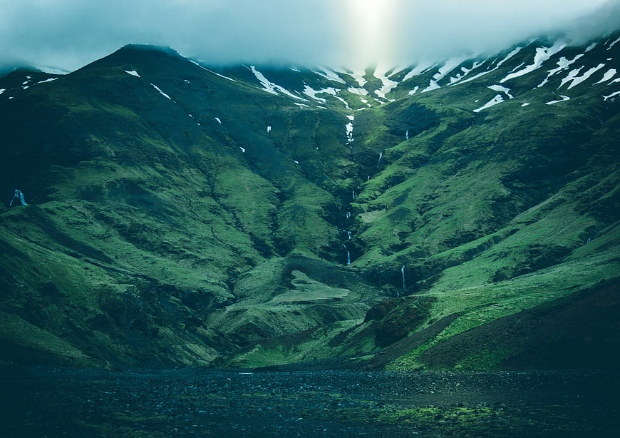 Dramatic Green Mountain Valley with Waterfalls and Snow