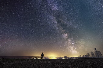 Silhouette of Man Under Milky Way Galaxy Night Sky