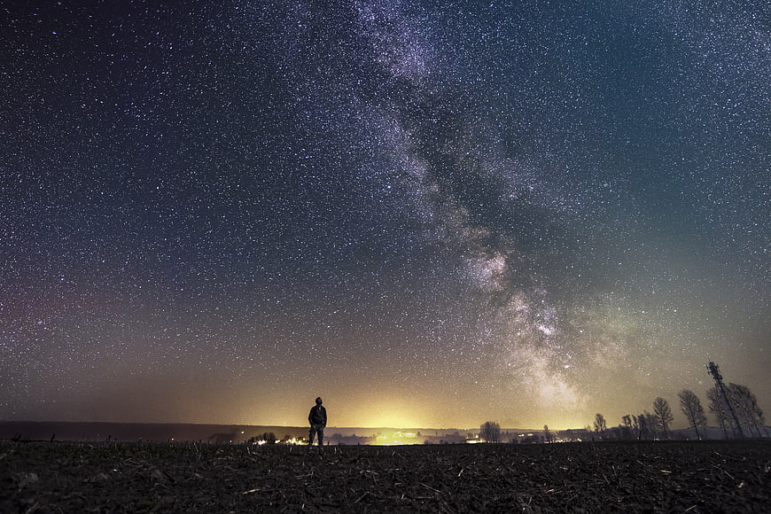 Silhouette of Man Under Milky Way Galaxy Night Sky