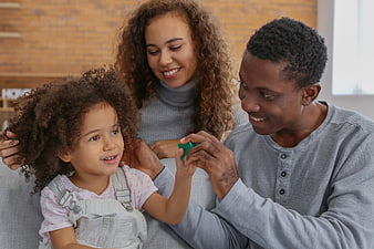 Happy African American Family Playing with Toy on Sofa